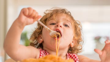 Niño comiendo pasta